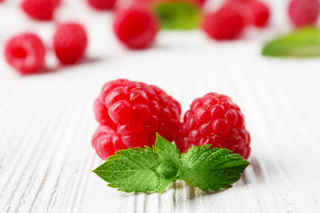 Fresh red raspberries on wooden table, closeup