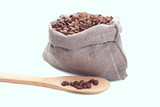 Fototapeta Storczyk - Wooden spoons with coffee beans on white background