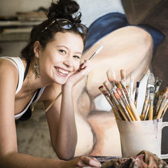 Young attractive artist working in art studio