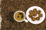 Fototapeta Boho - Coffee bean background with cup of fresh hot coffee and plate fu
