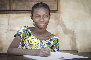 beautiful african teenage schoolgirl smiling at public school