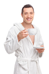 Poster - Young man in a white bathrobe holding a cup of tea