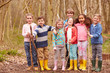 © micromonkey - Portrait Of Children Playing Adventure Game In Forest