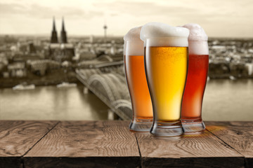 Glass of beer with view of Koeln on background