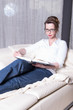 © Jürgen Hüls - attractive woman on couch reading a book