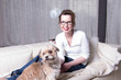 © Jürgen Hüls - attractive woman on couch with her dog