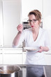 © Jürgen Hüls - attractive woman in modern ktchen cooking and eating soup