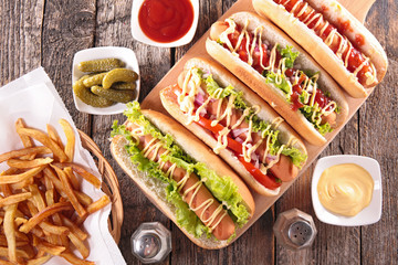 Wall Mural - hot dog on board with sauce and french fries