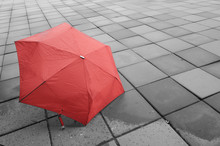 Red Umbrella On The Floor Wet After Rain.