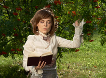 Girl Touches Rowan Berries And Reads Book