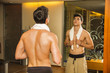 © theartofphoto - Young Man Admiring His Muscles in Mirror