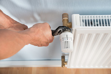 Sticker - Plumber Fixing Radiator With Wrench