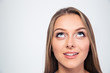 © Drobot Dean - Smiling young woman looking up