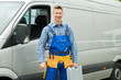 © Andrey Popov - Repairman With Tools And Toolbox In Front Of Van