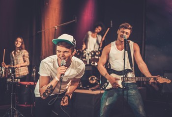 Wall Mural - Multiracial music band performing on a stage