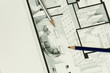 Two artistic drawing pencils set on actual real estate floor plan architectural isometric drawing stating for simplicity in interior design process and real estate business branch