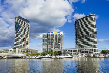 Modern apartments, marina and Webb Bridge, Docklands in Melbourne, Australia during daytime