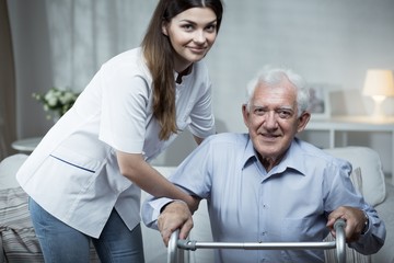 Canvas Print - Nurse helping disabled senior man