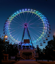 Ferris Wheel With Multi-colored Illumination Against Night Sky