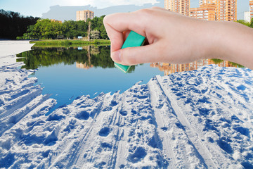 Wall Mural - hand deletes winter snow field by rubber eraser