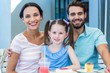 © WavebreakmediaMicro - Portrait of a family eating at the restaurant