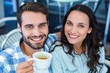 © WavebreakmediaMicro - Cute couple having coffee together