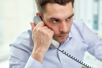 Canvas Print - face of businessman calling on phone in office