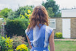 © LoloStock - Young woman standing in garden