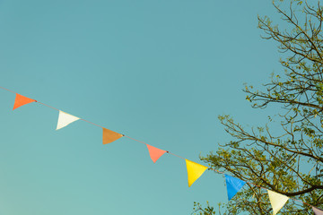 colorful festive bunting flags against a blue sky background