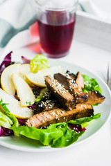 Wall Mural - Sliced meat steak with green salad and pears