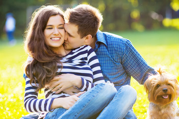 Lifestyle, happy family of two resting at a picnic in the park with a dog