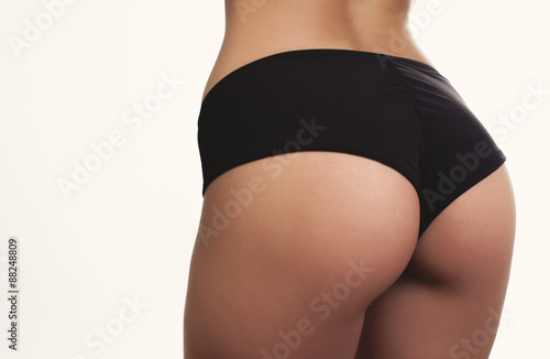 Fotografie, Obraz closeup woman beautiful buttocks over white background