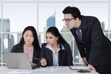 Wall Mural - Three entrepreneurs planning a job in office