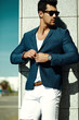 © halayalex - Fashion portrait of young sexy businessman handsome  model man in casual cloth suit in sunglasses in the street