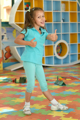 Wall Mural - little girl with thumbs up