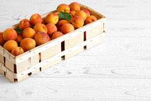Wood Box Of Whole Orange Apricots With Red Blush On Rustic White