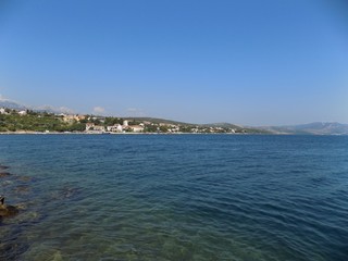 Sea, village, hills and blue sky