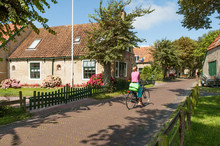 Street Scene With Woman On Bicycle In  Historical Town Hollum On West Frisian Island Ameland, Netherlands