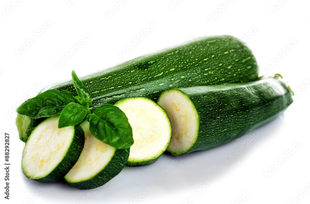 Fresh zucchini with basil isolated on white