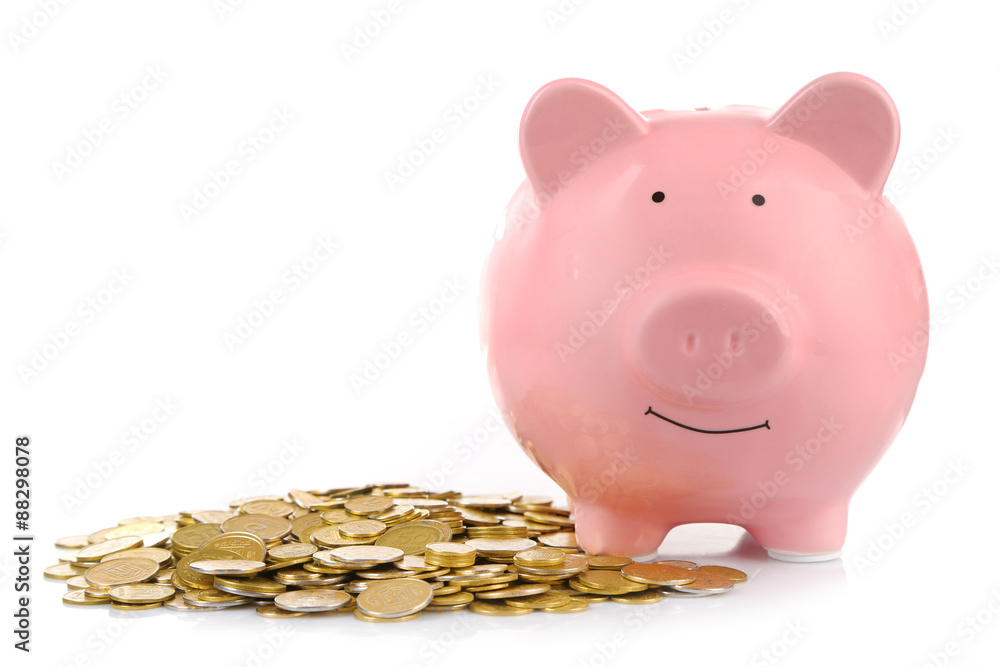 Pink piggy bank with coins isolated on white