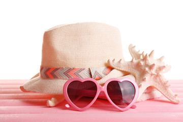 Summer accessories on wooden table isolated on white