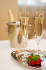 Two glasses of Champagne and strawberries on a table