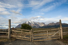 Cattle Gate With The Towers Of The Torres Del Paine National Park In Background, Patagonia, Chile 