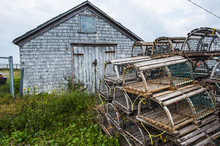 Fish Traps In Front Of A Shingle Hut In Neils Harbour, Cape Breton Highlands National Park, Cape Breton Island, Nova Scotia, Canada 