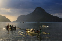 Outrigger Boat At Sunset In The Bay Of El Nido, Bacuit Archipelago, Palawan, Philippines