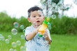 Little boy play with bubble blower at outdoor