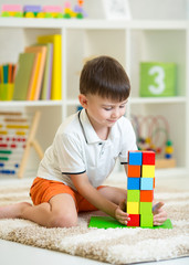 Poster - Child little boy playing with cubes, smiling