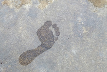 Wet Floor Of Foot Shape On Cement Background