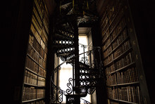 Spiral Staircase In An Old Library Of Books