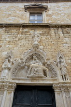 Statue Of Our Lady Of Sorrow And St. John The Baptist On The Portal Of The Franciscan Church, Dubrovnik. Croatia